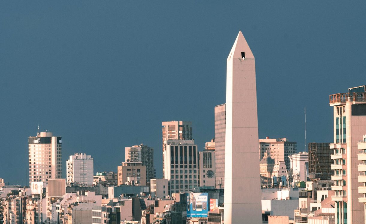 A stunning aerial view of Buenos Aires showcasing the iconic Obelisco surrounded by city skyscrapers.